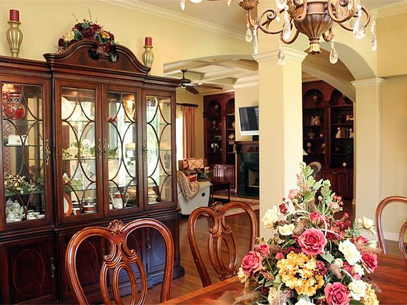 This view of the dining room shows the architectural touches of arches, columns and coffered ceilings.