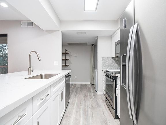 Upgraded kitchen counter tops. Touch activated kitchen faucet
