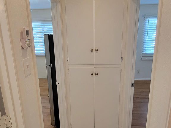 Hallway looking north living area on the left, Bedroom 1 on the right.