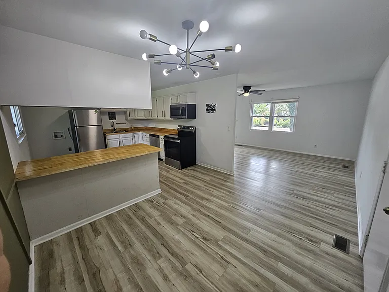 View from Back of Dining Room - open kitchen bar and living room.