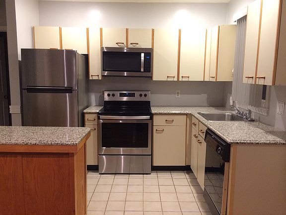 Kitchen - granite counters, stainless fridge, range and microwave. Dishwasher and disposal. Ample storage.