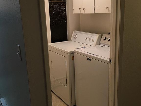 In-unit laundry room with storage