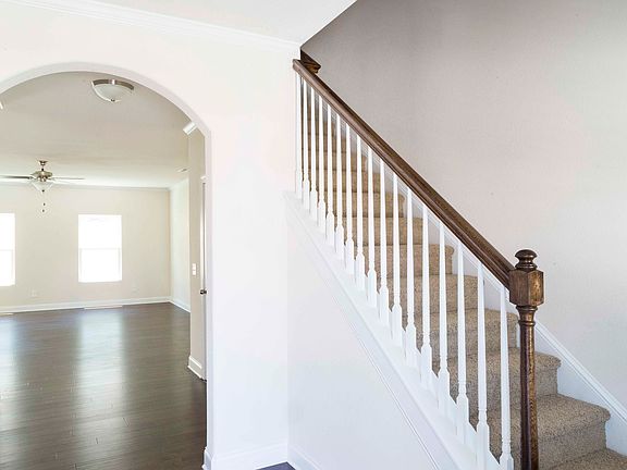 Entry features gorgeous arch details and leads to living room