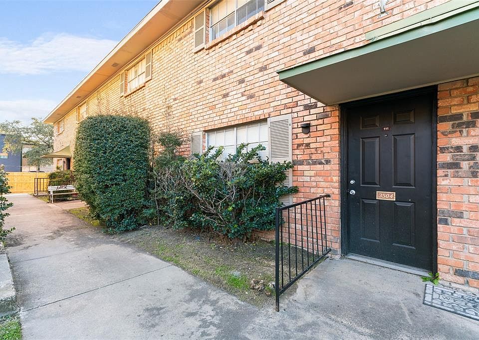 Doorway to property featuring brick siding