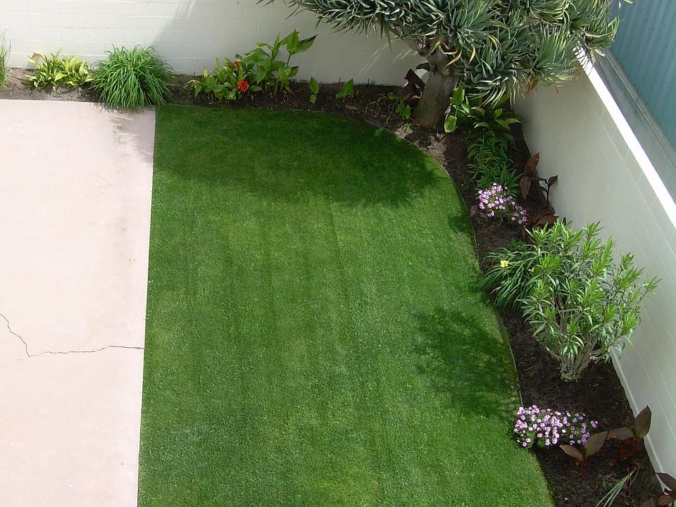 View from Balcony of neighbors grass/yard. (Gardener maintai