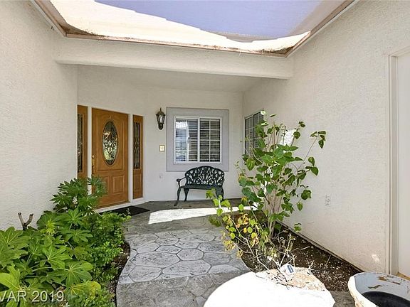 Gated courtyard entry. Door to right is separate entry for guest quarters.