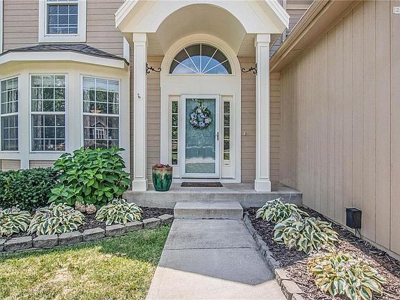 Love the curb appeal with the beautiful landscaping with hostas and hydrangeas.