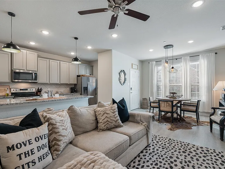 Open-concept living space with light-toned wood-finish flooring