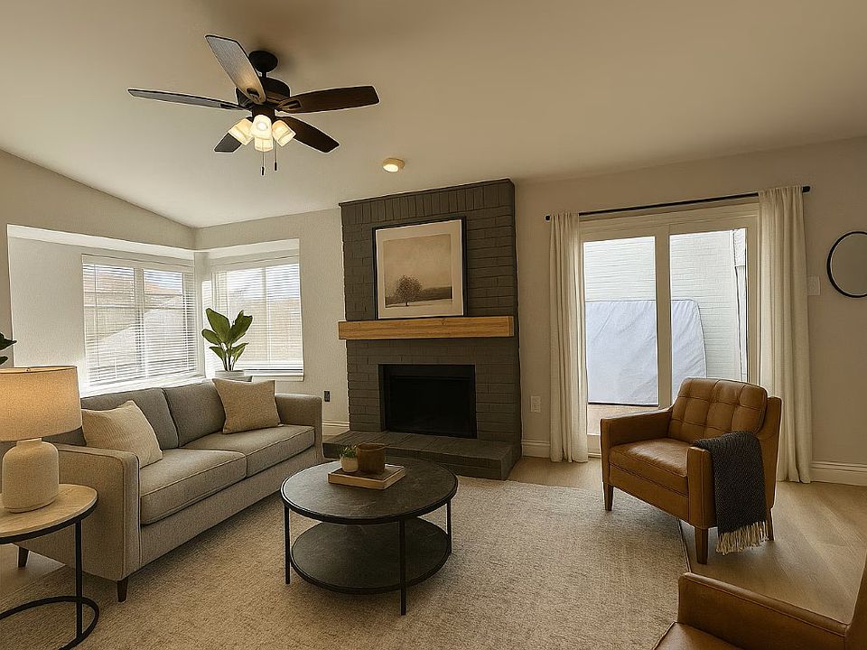 lots of natural light in the living area with door leading to fenced in back yard (virtually staged)