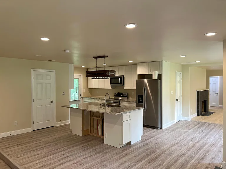 Chef's kitchen with oversized island, stainless appliances, and walk-in pantry _ perfect for cooking and entertaining.