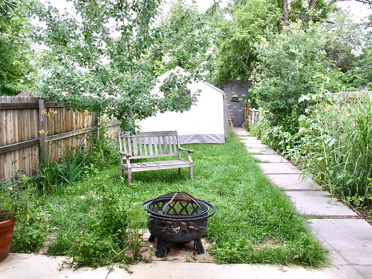 Large backyard. Structure at back is no longer there. Opportunity to garden - if you want to cultivate a garden I will invest in the raised beds.