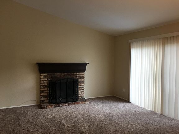 Living room freshly painted with vaulted ceiling, wood burni