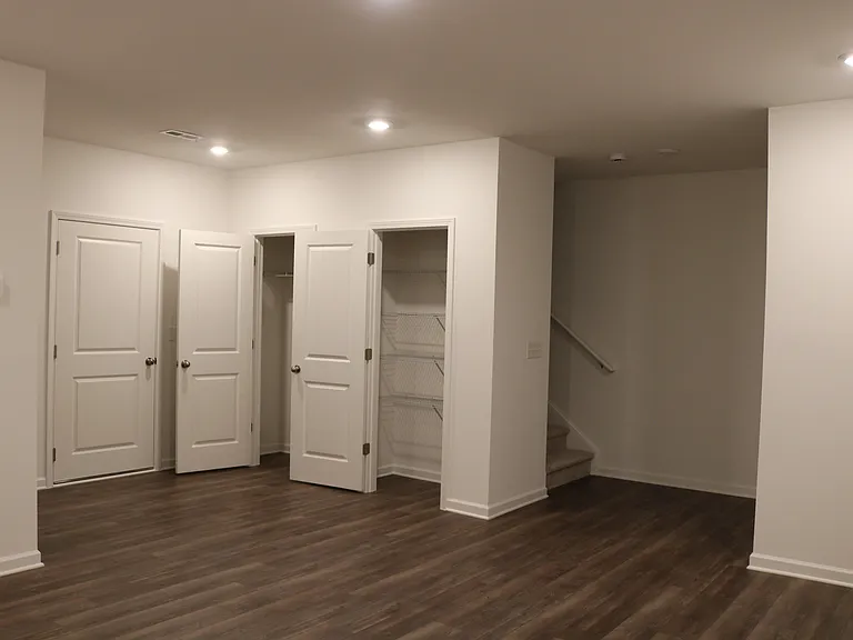 Recreation room with coat closet & linen closet.
