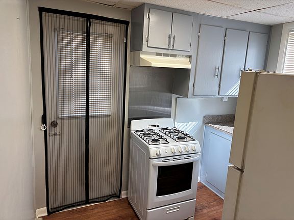 Kitchen with access to rear parking pad.