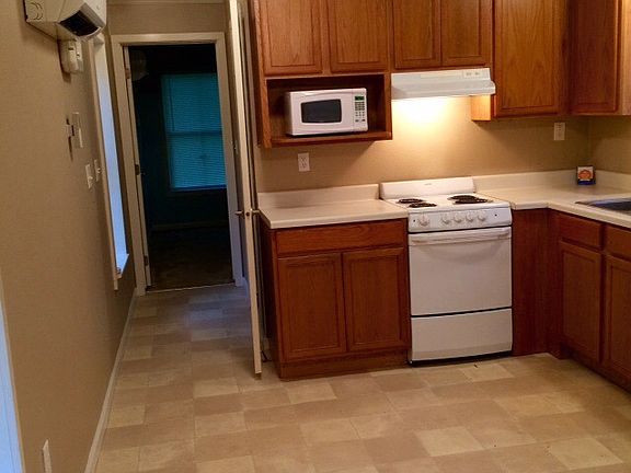 Kitchen with stove, fridge, microwave