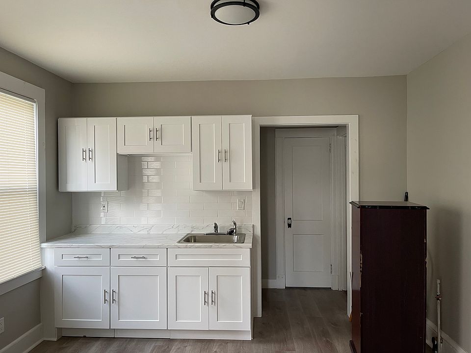 Large eat-in kitchen with new cabinetry. Entry to back hallway and side alternate entrance to apartment.