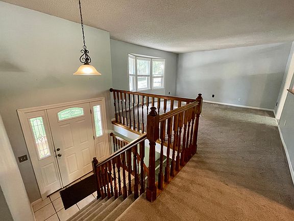 Looking from the hallway to the front entry and living room