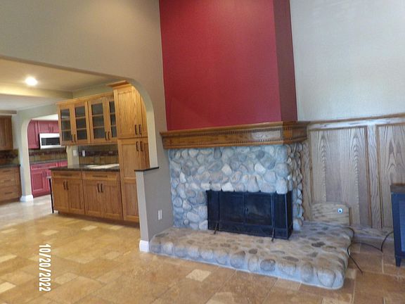 Large fireplace between the living room area and the Kitchen.