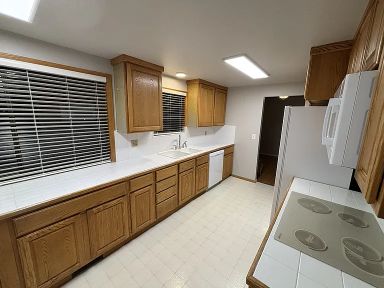 View of kitchen showing plenty of storage and newly installed countertop with abundant counter space