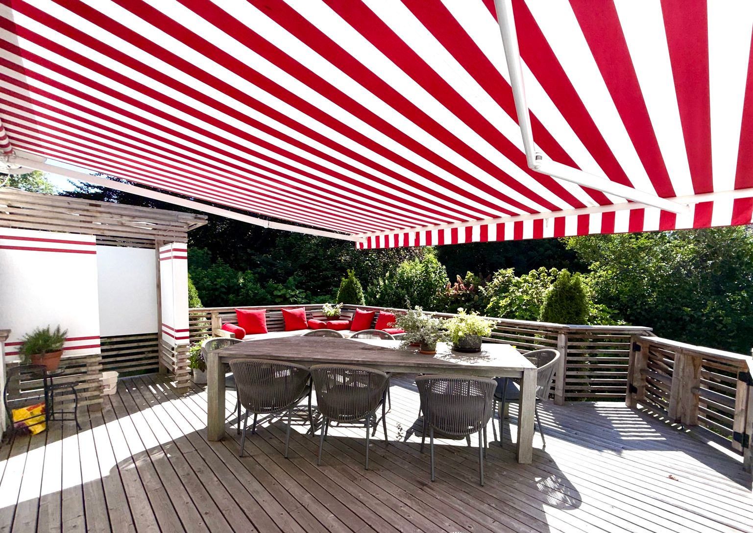  Deck off kitchen with electric awning , dining table with seating for 8, outdoor shower, gas grill