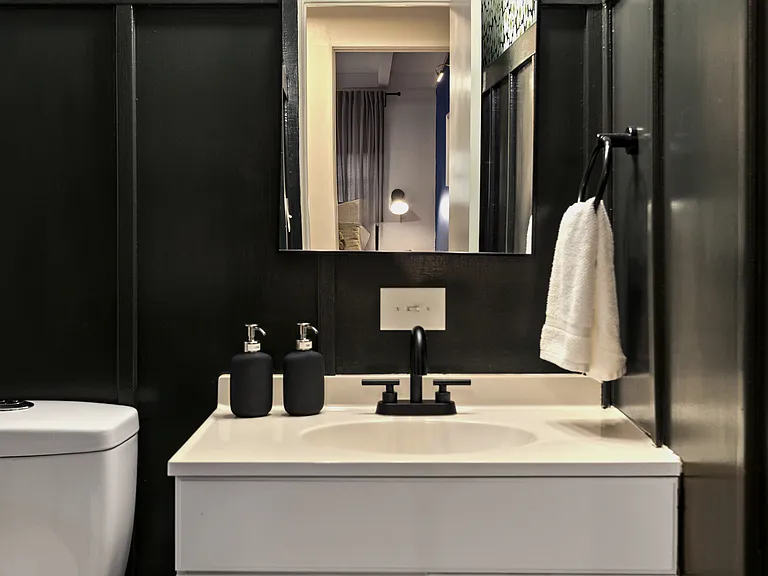 Hall bath vanity and mirror