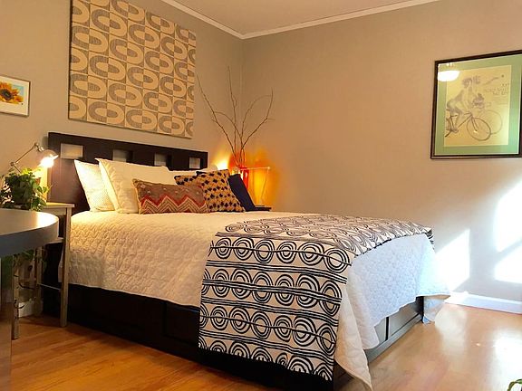 One of the two first floor bedrooms with great views of backyard, the grand Western Red Cedar, Japanese Maple and raspberry patch.