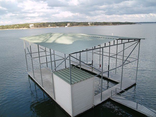 Boat dock holds a 40' boat, has electricity and water, storage & refrigerator
