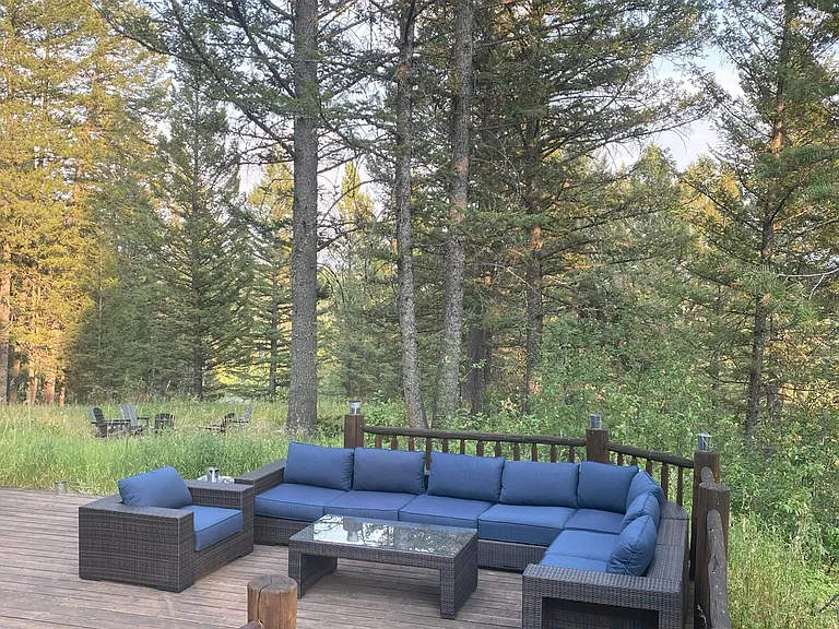 large 2 level deck, porch with living area, dining table, and spa