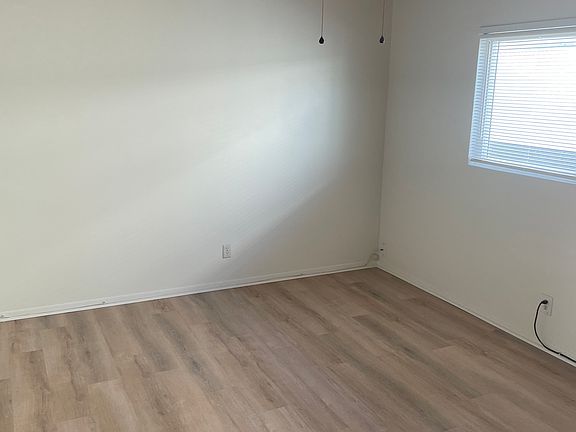 View of bedroom with ceiling fan.