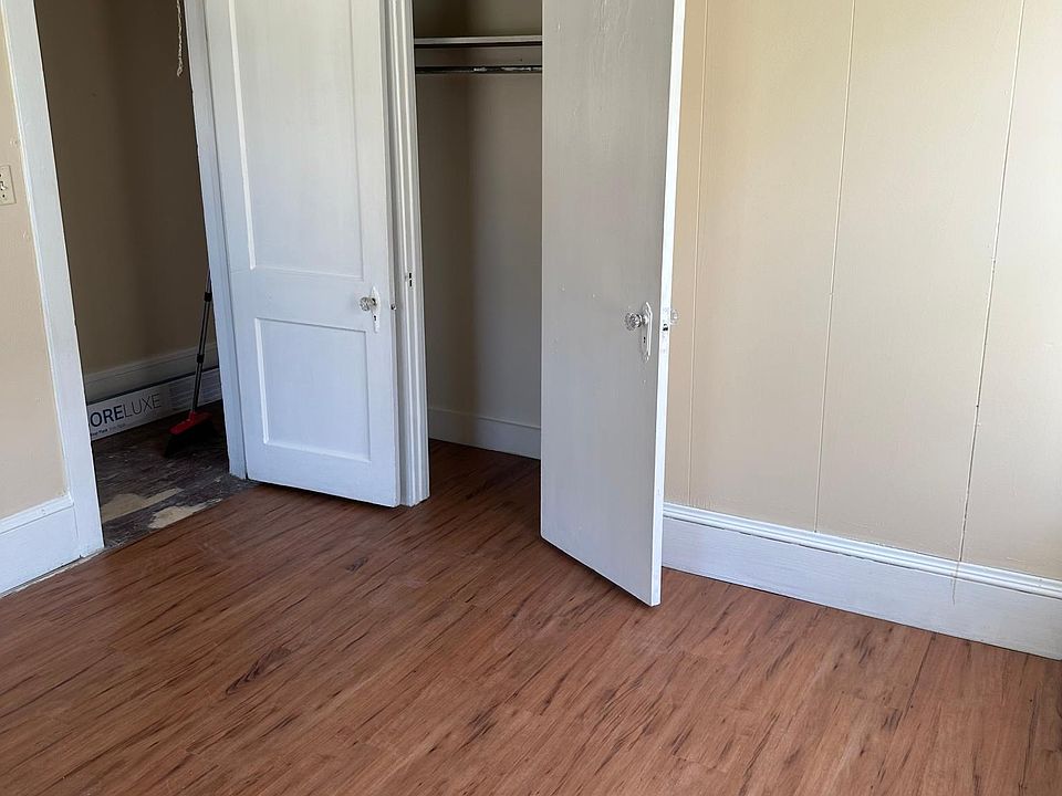 Front bedroom looking at closet and door leading to living room.