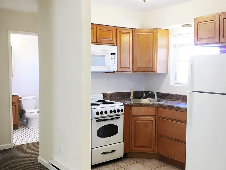 Kitchen with stove microwave and large fridge.