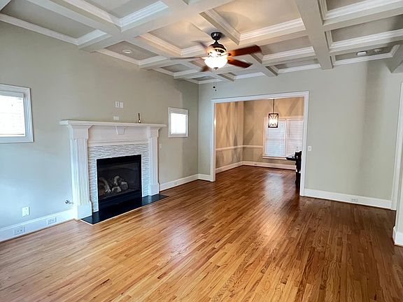 Spacious and well illuminated living room, with hardwood floors throughout.