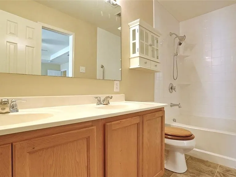 Primary bathroom with dual sinks, tub and separate shower.