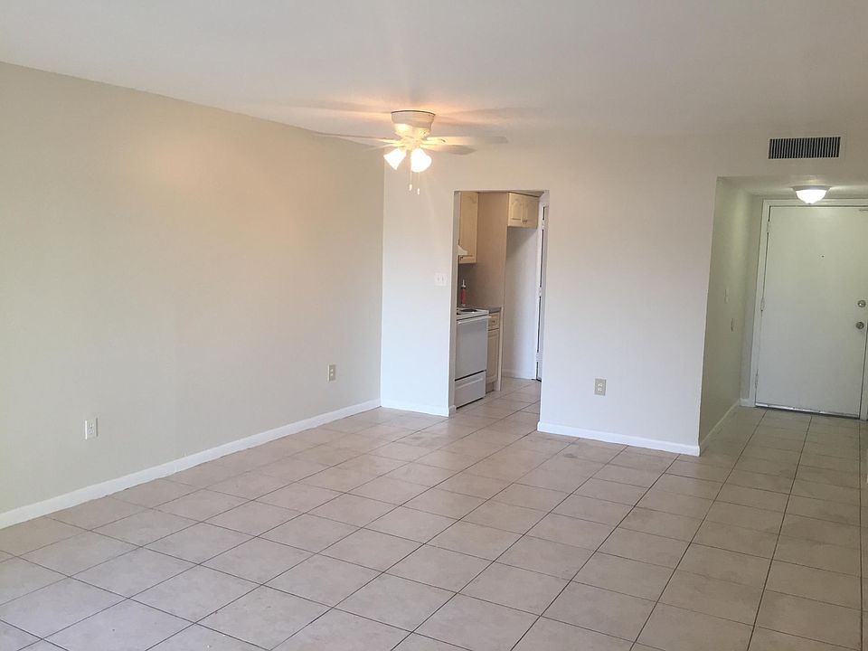 spacious well lit living dining area with front door and kitchen door