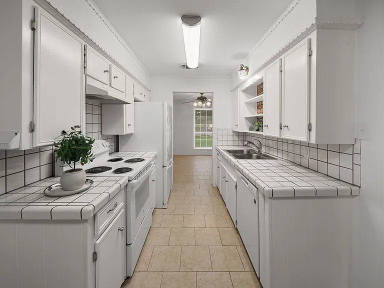 Galley Kitchen looking into the front dining area with room for a breakfast table or pantry shelves and countertop behind