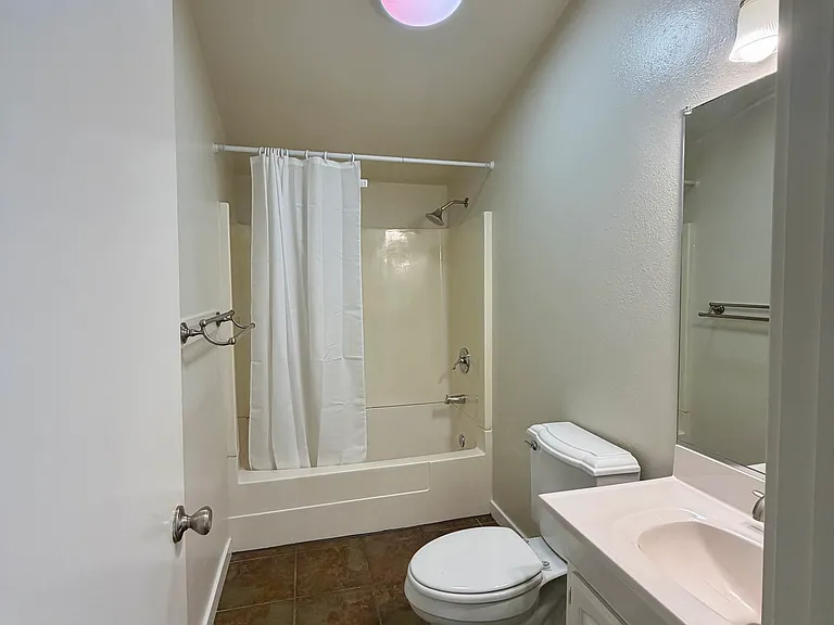 Upstairs bathroom with shower over bathtub combination