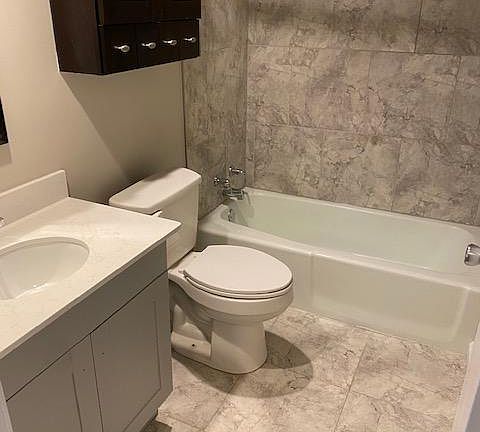 Bathroom with tiled shower.