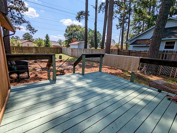 View of the fenced in backyard from the large back deck perfect for grilling and entertaining