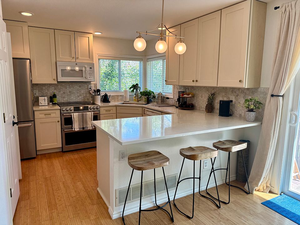Newly updated kitchen with all new cabinets, countertop, backsplash, and appliances (including induction cooktop).