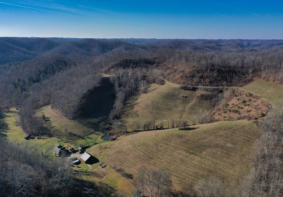 Aerial drone view from the northeast corner of the property looking southwest over the home and structures
