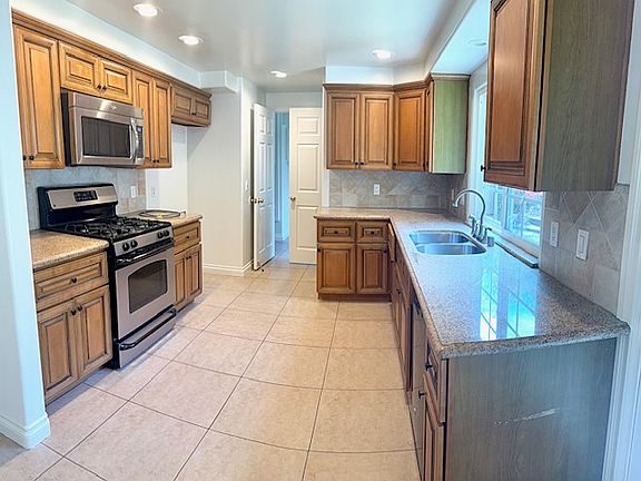 Kitchen microwave and stove are being replaced with new appliances.