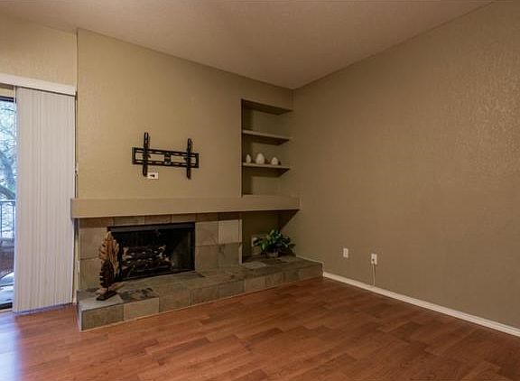 Complete with a wood burning fireplace and already updated to provide the perfect place for your wall mounted TV! Additional shelving is ready for your favorite books or collectibles. Don't want to store the wood? Perhaps it's a perfect space for the dog 