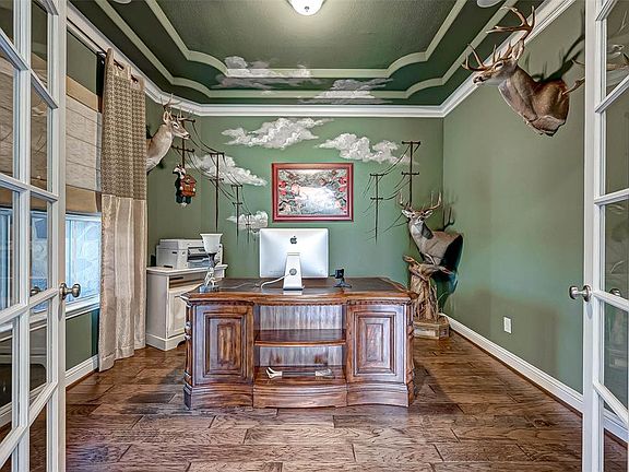 Your office features French Doors, a Double Tray Ceiling and Crown Molding.