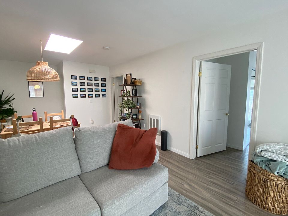 View of living room / dining room and a bedroom entry.