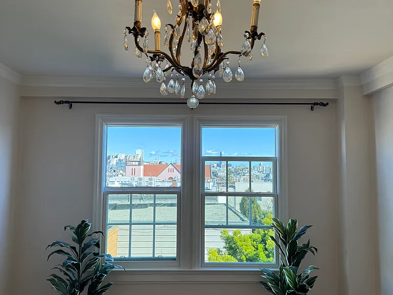 Freshly painted living room with cable and internet connections ready to go. Modern windows open from top and bottom. French chandelier included.