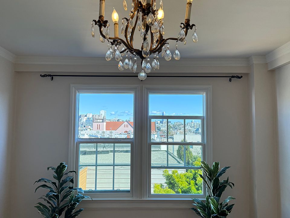 Freshly painted living room with cable and internet connections ready to go. Modern windows open from top and bottom. French chandelier included.