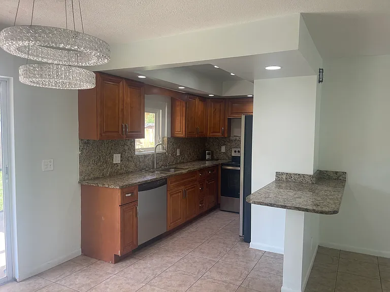 Kitchen with wood cabinets and granite countertops.