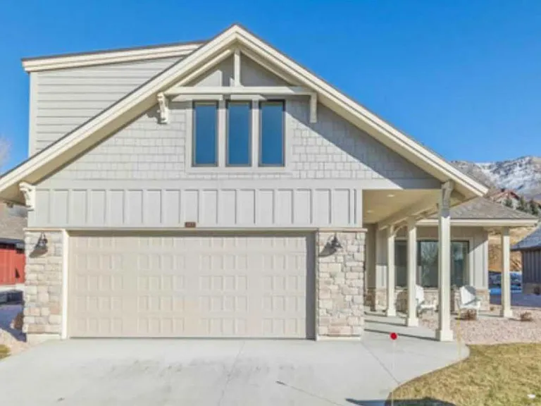 Front of home with two car garage and ample driveway parking