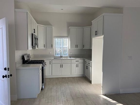Kitchen with microwave and gas stove