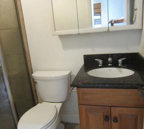 Glass shower surround with Ceramic Tile wainscoting.